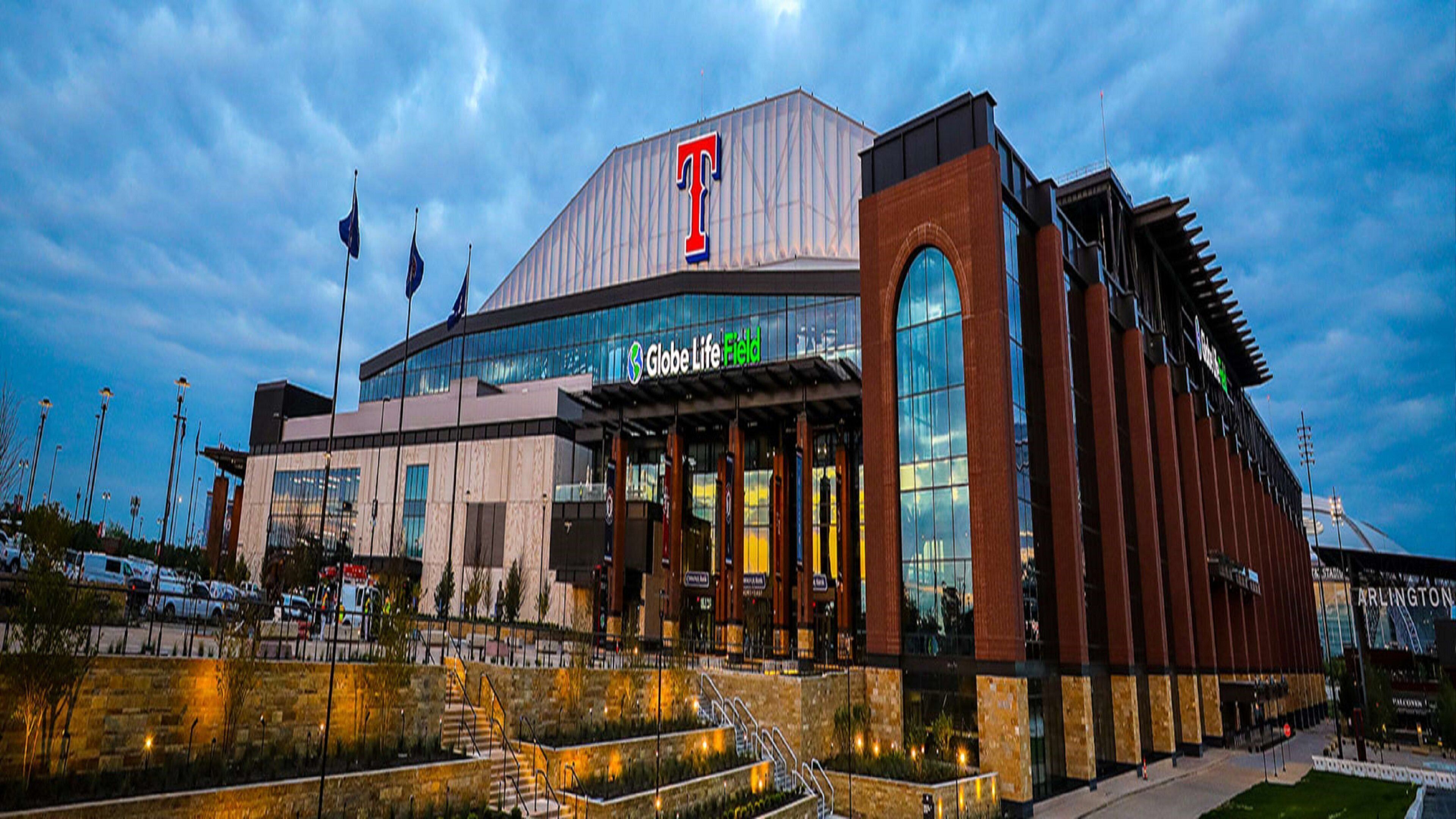 A modern building with a prominent 'T' logo, a large glass entrance, and a well-lit facade.