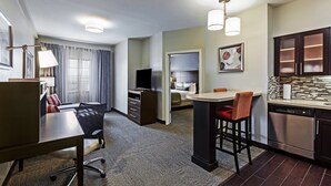 A hotel room with a dining area, kitchenette, and a separate bedroom. - Staybridge Suites Fort Worth - Fossil Creek by IHG (Fort Worth)