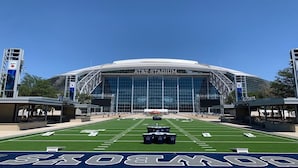A stadium with a large field marked for football, AT&T Stadium, and a large digital screen at the end of the field. - Staybridge Suites Fort Worth - Fossil Creek by IHG (Fort Worth)