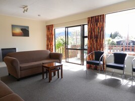 Three Bedroom Apartment | Living area | 50-inch Smart TV with digital channels