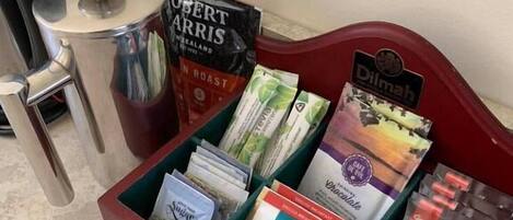 A coffee station with various brands of coffee and tea, including 'Robert Harris Roast' and 'Dilmah'.