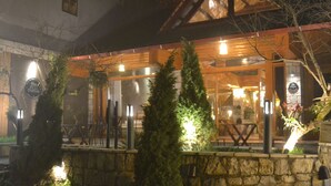 A stone-walled building with a wooden facade and a glass entrance. - The Hill Station Boutique Hotel (Sa Pa)