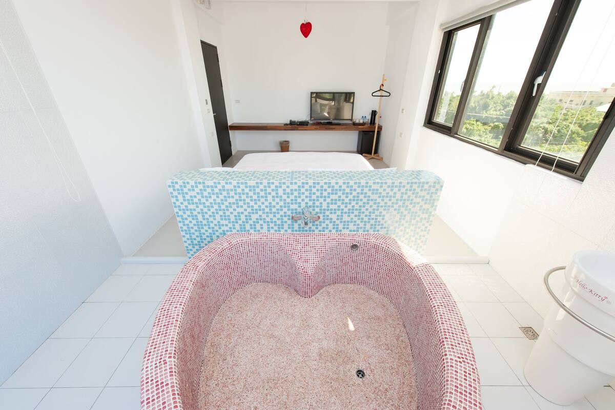 A modern bathroom with a freestanding bathtub, a shower area, and a toilet.