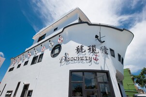 Un edificio blanco con techo curvo y un letrero que dice 'Discovery'.