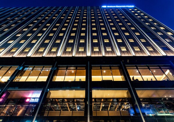 A high-rise building with a grid of windows and a central entrance. - Daiwa Roynet Hotel Ginza PREMIER Renewal Open March 9th, 2026 (Tokyo)