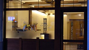 A restaurant with a wooden interior, a counter with a coffee machine, and a sign that reads "B&B Coffee & Bread". - Hualien Little Squirrel B&b (Hualien City)