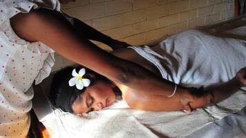 Guests can rest in comfort on the plush bed, surrounded by a serene atmosphere.