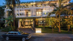 A modern hotel with a two-story structure, a car parked in front, and a sign reading "VIROTH'S". - Viroth's Hotel (Siem Reap)
