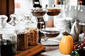 A buffet table with various food items and condiments.