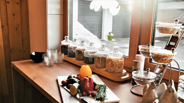A breakfast buffet setup with various food items and condiments.