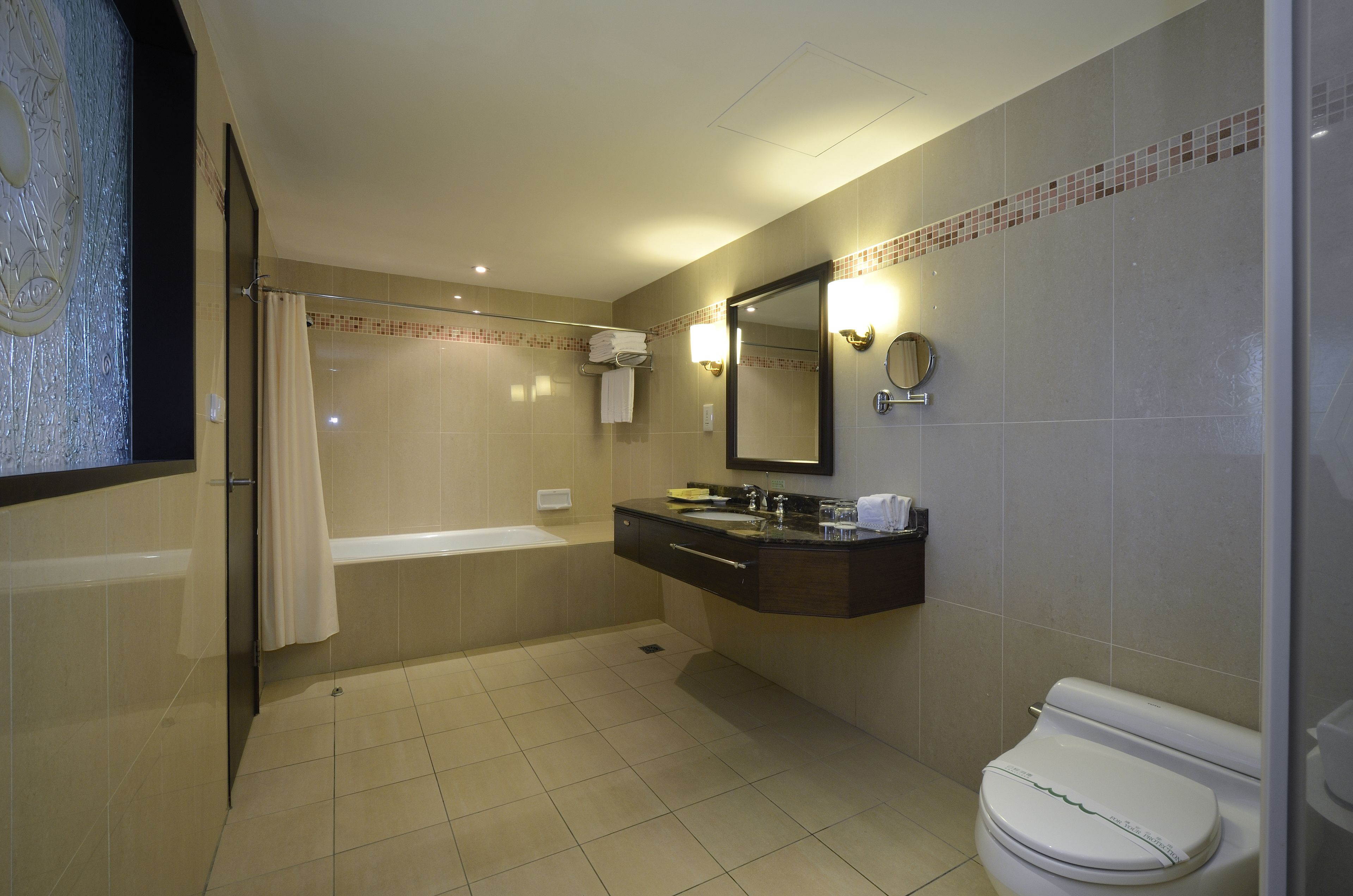 deluxe quadruple room | bathroom | hair dryer, slippers, towels