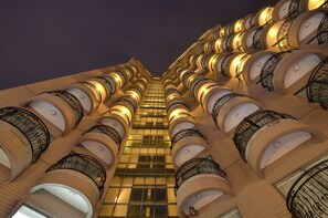 A high-rise hotel with multiple balconies and a modern architectural design. - Hotel RegaLees (New Taipei City)