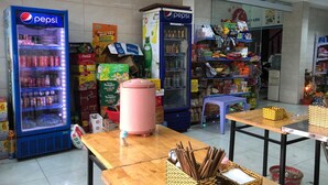 A small convenience store with Pepsi vending machines, a variety of snacks, and household items.