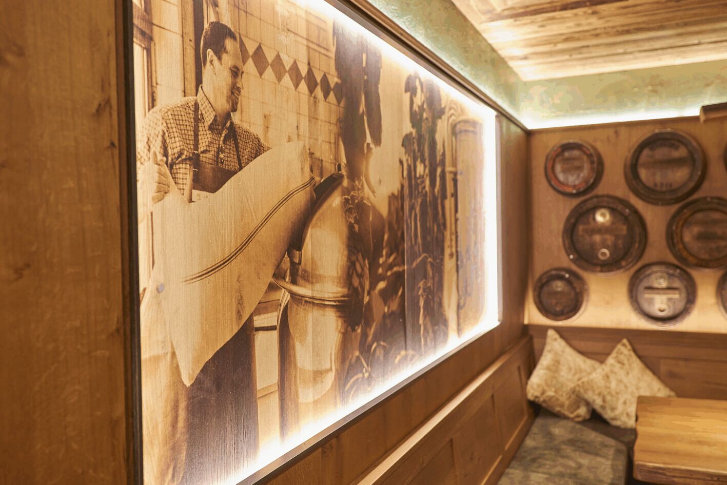 A wall with a large framed picture of a man playing a guitar, wooden paneling, and a wall-mounted display of circular objects.
