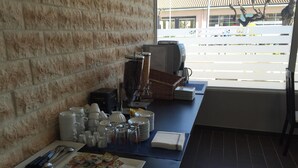 A breakfast buffet setup with various dishes, utensils, and condiments. - Le Logis Dauphinois (Roussillon-en-Isere)