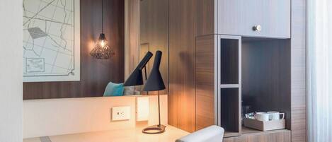 A modern office space with a desk, chair, and built-in shelving unit.
