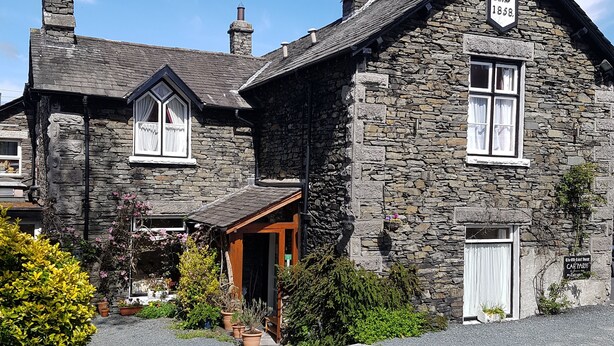 A stone building with a sign reading "A.D 1858". - The Old Courthouse (Windermere)
