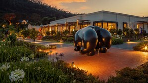 A modern building with a large sculpture in front. - Leeu Estates (Franschhoek)