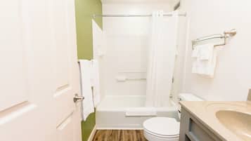 A bathroom with a bathtub, toilet, and sink.