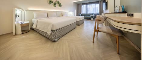 A modern hotel room with a large bed, a desk, a chair, a TV, and a bathroom.