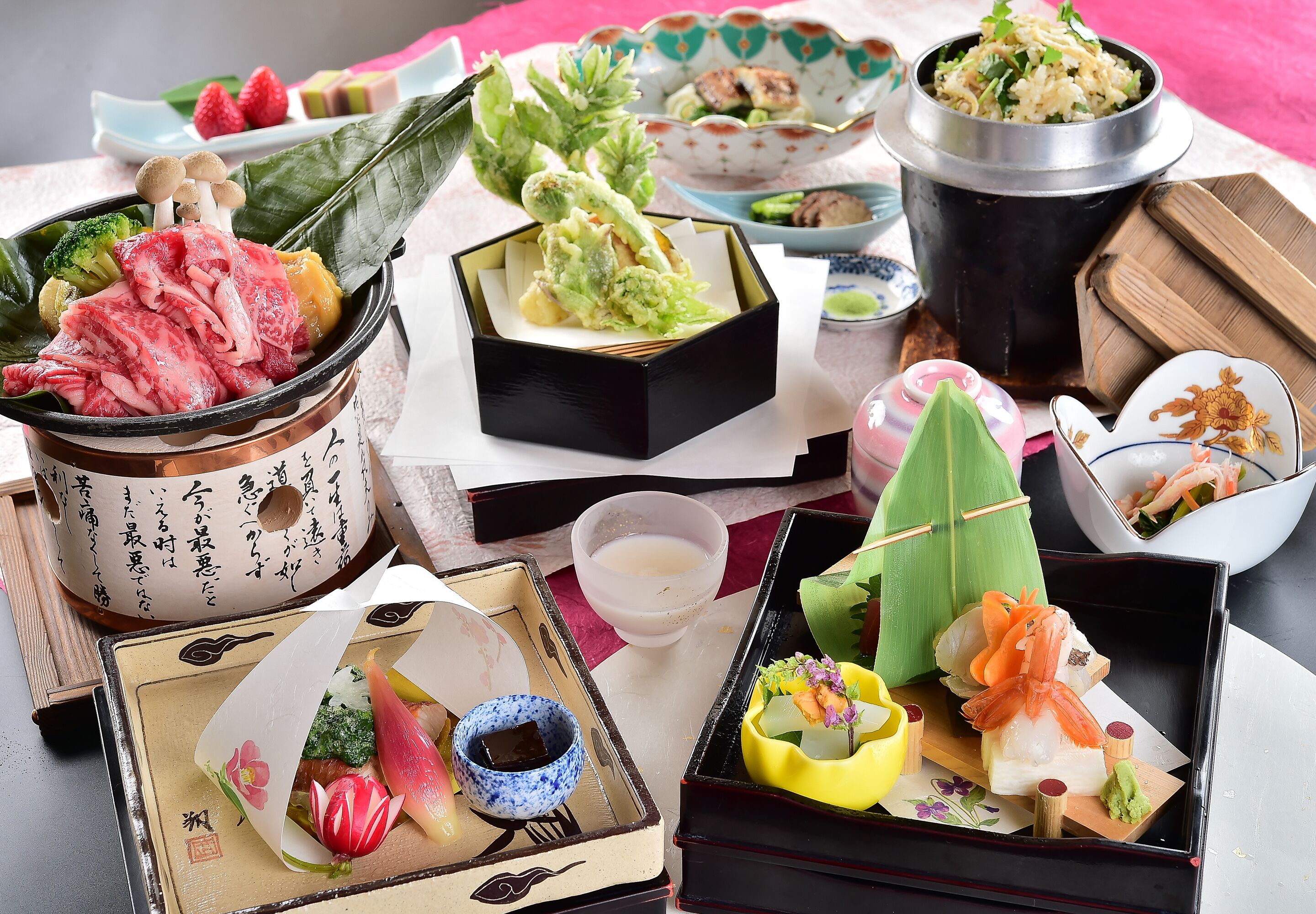 A variety of traditional Japanese dishes arranged on a table, including sushi, sashimi, and pickled vegetables.