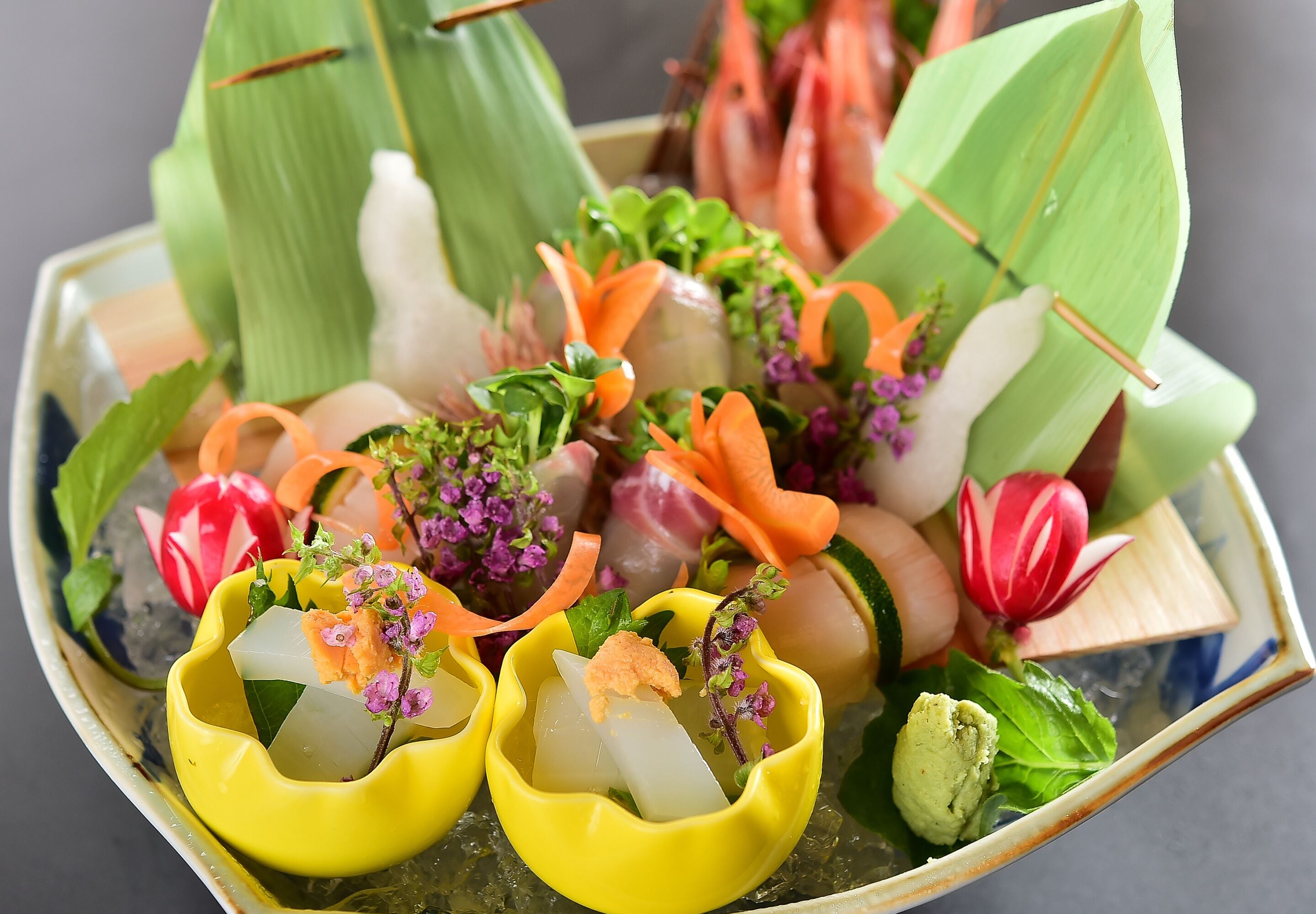 A seafood dish with various garnishes and decorative elements.