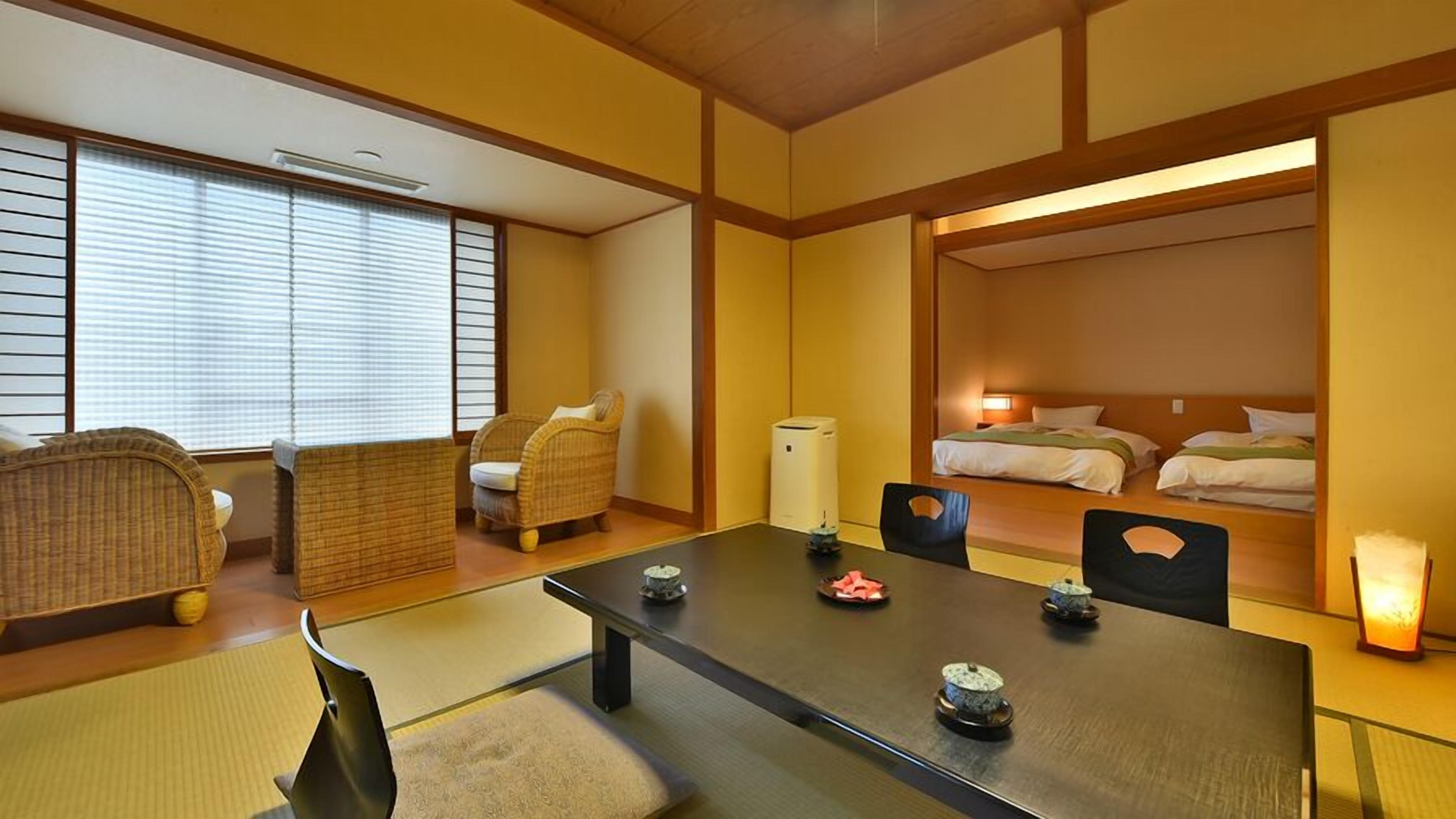 A traditional Japanese-style room with tatami flooring, a low table with tea sets, a futon bed, and a sliding door leading to another room.