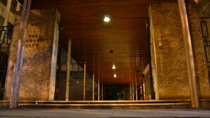 A building entrance with a wooden ceiling and a sign reading "The Arare Club".