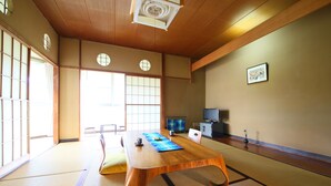 A traditional Japanese room with tatami flooring, a low wooden table, and sliding shoji doors. - Hotel Miyama (Chichibu)