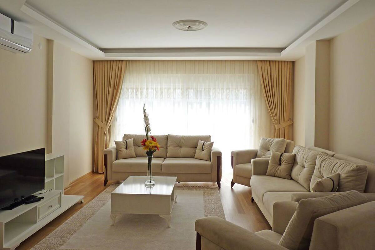 A living room with two sofas, a coffee table, and a TV.