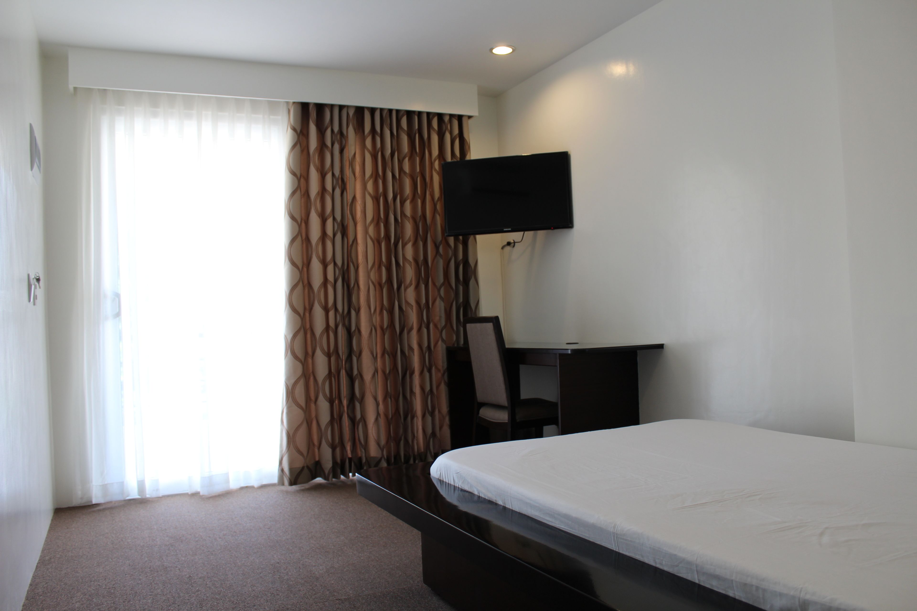 desk, blackout curtains, soundproofing, rollaway beds