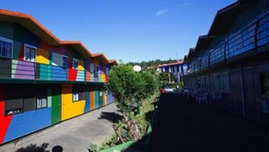 A row of colorful buildings with a clear sky. - Compostela Inn (Teo)