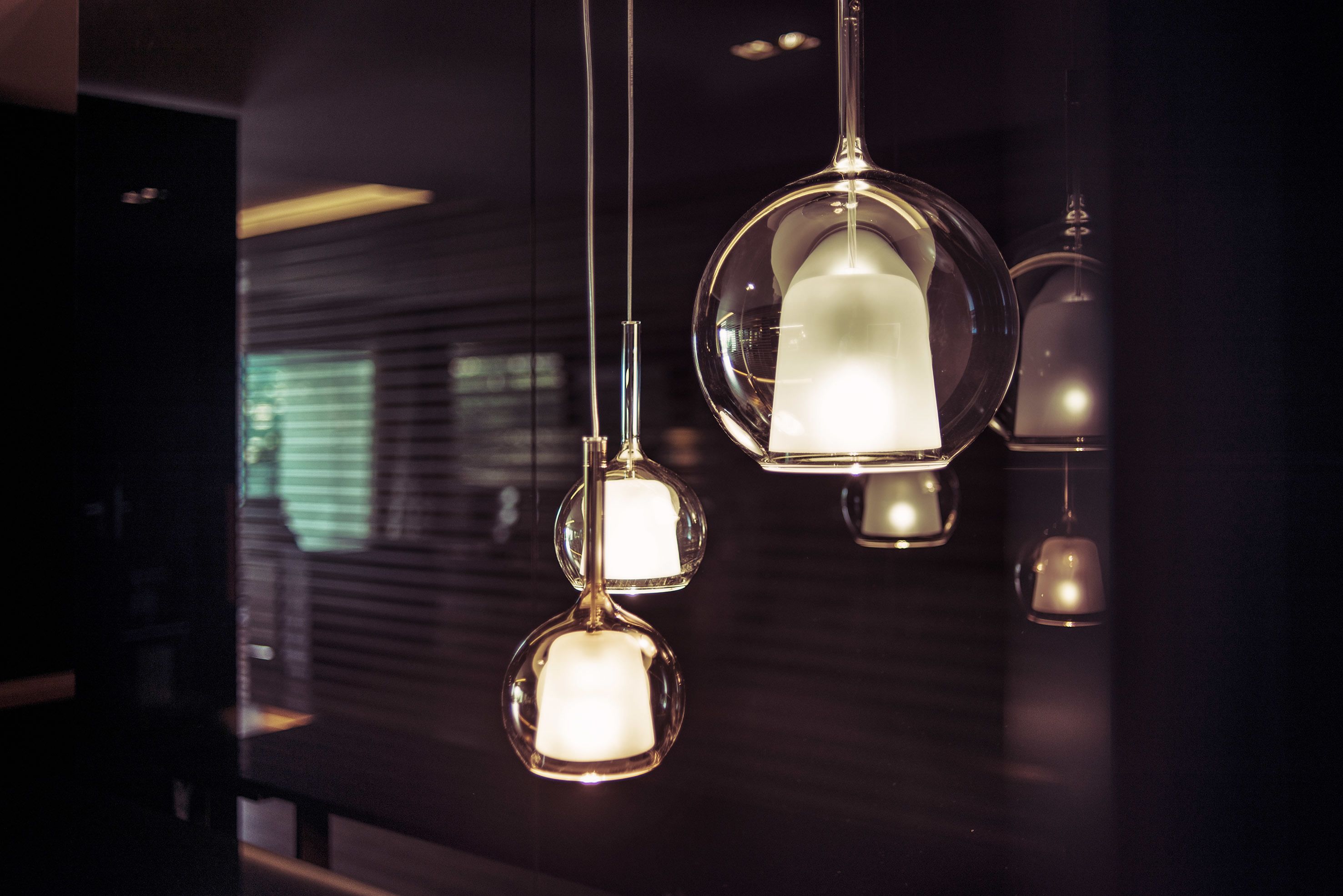 A modern interior with hanging spherical light fixtures.