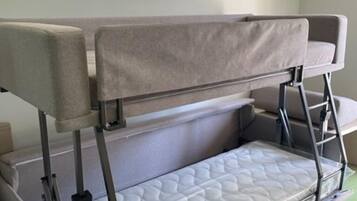 Compact foldable bed unit with a quilted mattress and adjustable metal frame.