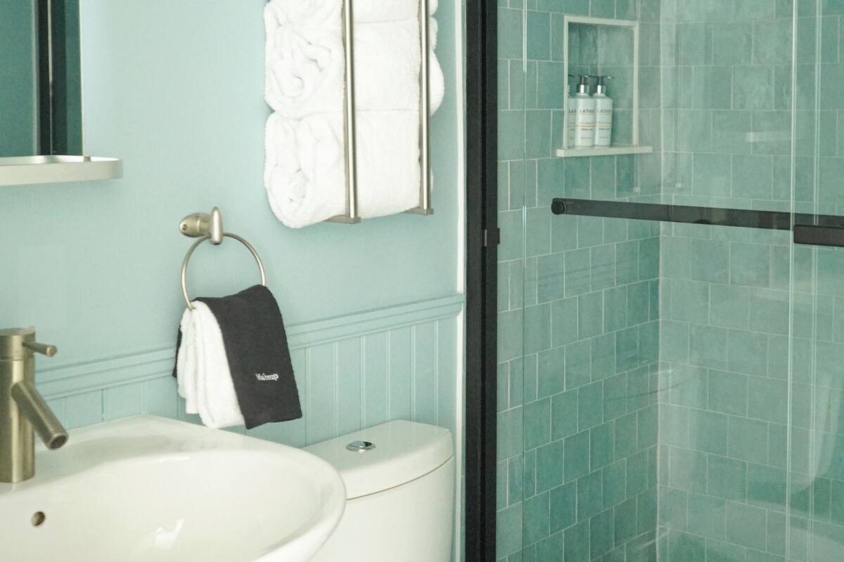 combined shower/bathtub, designer toiletries, hair dryer, bathrobes