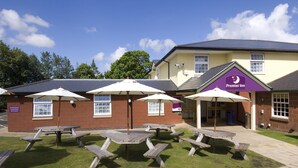 A Premier Inn with outdoor seating and a clear sky. - Premier Inn Shrewsbury North - Harmer Hill (Shrewsbury)