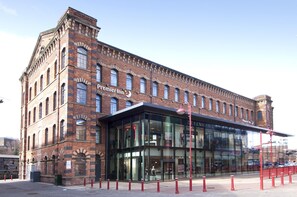 A brick building with a glass entrance and signage for Premier Inn.