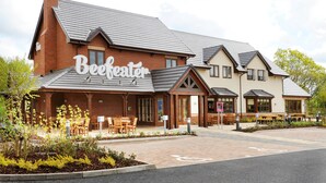 A building with a sign reading 'Beefheaton' and outdoor seating.