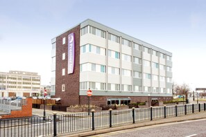 A multi-story hotel with a prominent 'Premier Inn' sign, a brick facade, and a gated entrance. - Premier Inn Birkenhead Town Centre (Birkenhead)