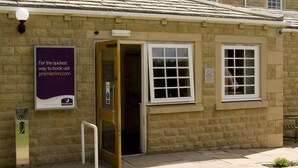 A stone building with a sign for Premier Inn, a wheelchair ramp, and a no smoking sign. - Premier Inn Skipton North - Gargrave (Skipton)
