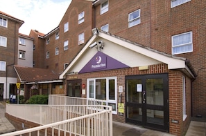 Ein Backsteinhaus mit einem 'Premier Inn'-Schild, einem verschlossenen Eingang und einem Schild mit der Aufschrift 'Hier bezahlen'.
