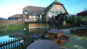 A building with a sign reading "Frye & Square" and a water wheel. - Premier Inn Eastbourne (Eastbourne)