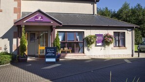 A building with a sign reading 'Premier Inn' and a welcome sign outside. - Premier Inn Dumfries (Dumfries)