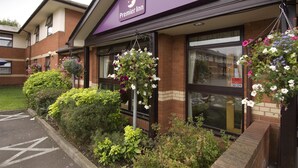 A Premier Inn hotel with a purple awning, hanging flower baskets, and a brick facade. - Premier Inn Coventry - Binley/A46 (Coventry)
