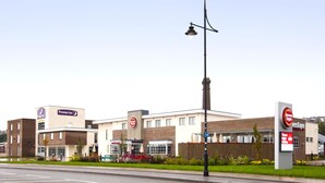 A hotel with a prominent Premier Inn sign, outdoor seating, and a visible restaurant sign. - Premier Inn Barry Island (Barry)