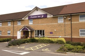 A hotel named 'Premier Inn' with a brick facade, a parking lot with disabled parking spaces, and a sign indicating a car park. - Premier Inn Scunthorpe (Scunthorpe)