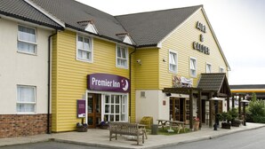 A yellow building with a 'Premier Inn' sign, a bench, and outdoor seating. - Premier Inn Goole (Goole)