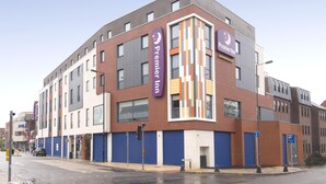 A modern hotel building with multiple floors, prominent signage, and a clear blue sky. - Premier Inn Camberley (Camberley)