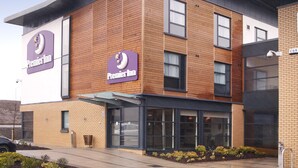 A Premier Inn hotel with a modern design, featuring a brick facade and large signage. - Premier Inn Glasgow Newton Mearns - M77 J4 (Glasgow)