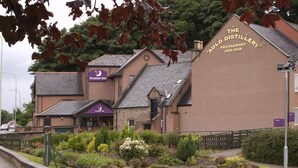 A building with a sign for 'The Auld Distillery Restaurant and Bar' and a 'Premier Inn' sign. - Premier Inn Inverness Millburn Rd (Inverness)